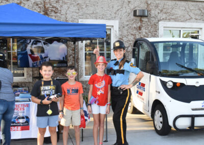 A Curtis Security Officer with some kids at an event